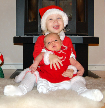 A picture of Emilia and Filippa in Christmas outfits