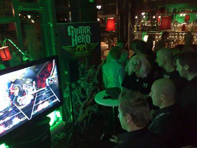 A picture from inside the Spotify party, with some people playing Guitar Hero